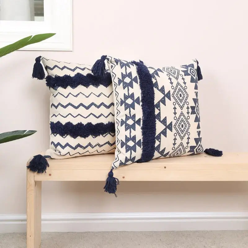 Two rectangular cushion covers with decorbites ethnic geometric printed navy and white patterns and dark blue tassels