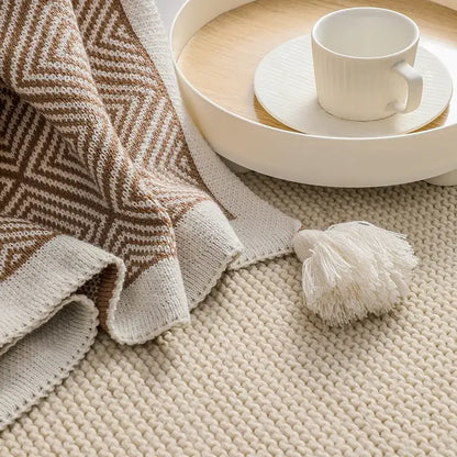 Beige and brown ethnic geometry knitted throw blanket with white tassel accent for living room sofa decorbites decor