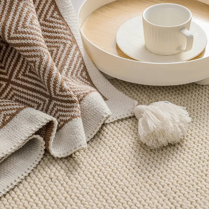 Beige and brown ethnic geometry knitted throw blanket with white tassel accent for living room sofa decorbites decor