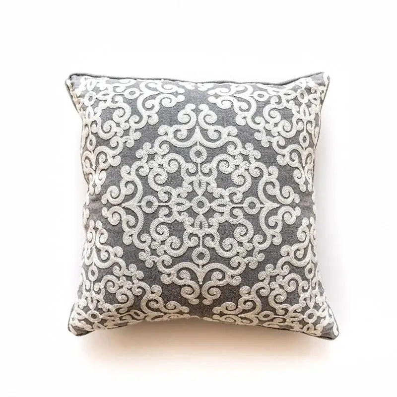 Gray cushion cover with intricate white embroidered ethnic swirl pattern for decorbites ethnic pattern decor