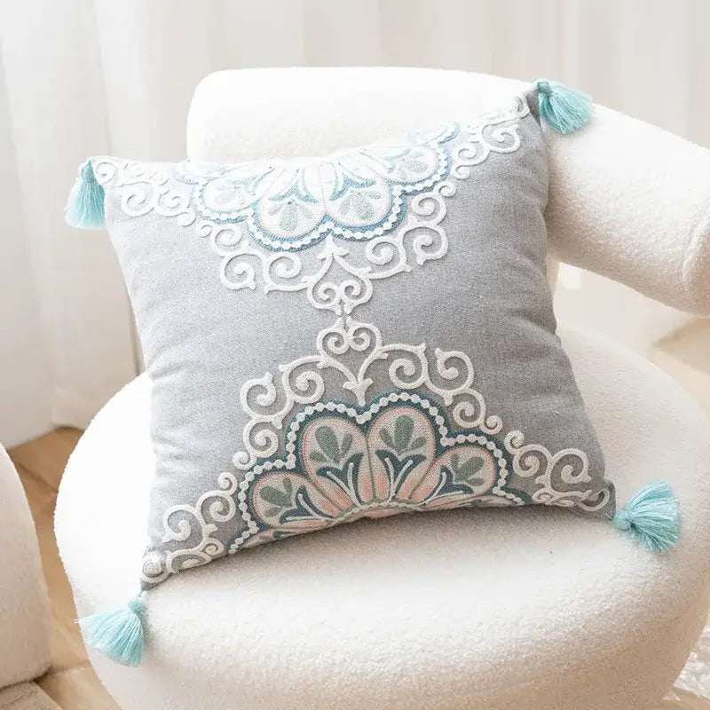 Ethnic gray and white swirl cushion cover with intricate floral embroidery and light blue tassels for living room decorbites ethnic pattern cushion