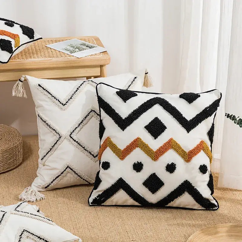 White throw pillow cushion cover with black and orange geometric patterns and textured tassels decorbites ethnic style black