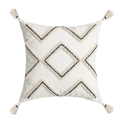 Cream-colored square cushion cover with black and cream geometric embroidery and tassels decorbites ethnic style black