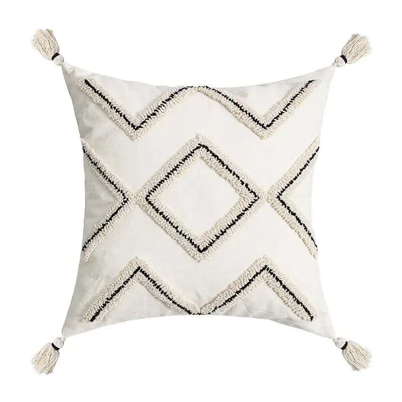 Cream-colored square cushion cover with black and cream geometric embroidery and tassels decorbites ethnic style black