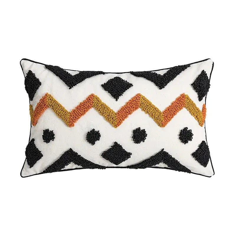 White rectangular cushion cover with ethnic style black and orange zigzag pattern and textured tufted accents by decorbites
