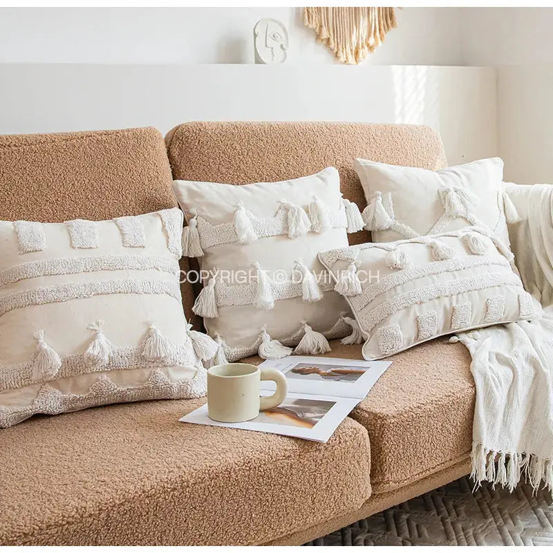 Cream-colored ethnic tufted cushion case with textured fabric tassels and embroidered details for living room decorbites ethnic tufted pillow