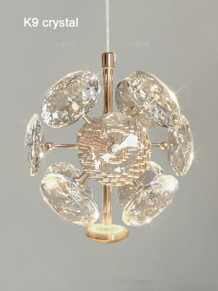 A radiant gold-toned European mini pendant light with polished chrome and faceted k9 crystal discs starburst design