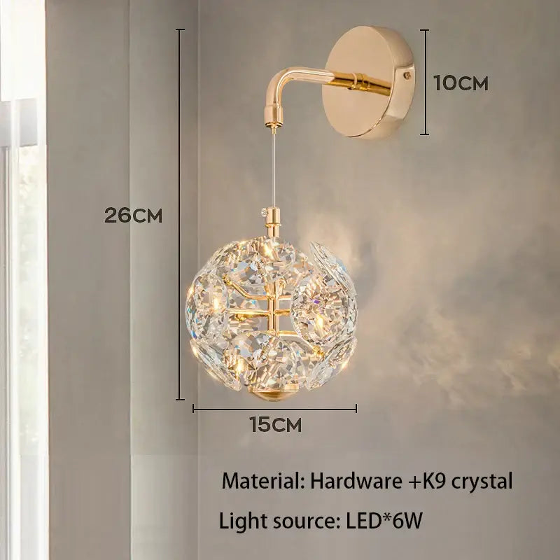 Gold-toned mini pendant light with a spherical crystal globe and polished chrome curved arm for dining room lighting
