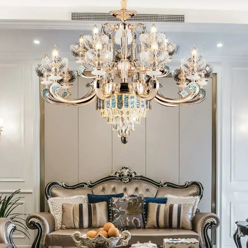 European gold and teal crystal dining room chandelier with ornate gold tone and mosaic accents above a sofa decorbites crystal dining