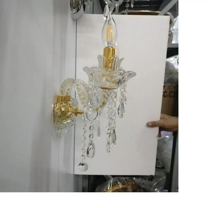 Elegant european gold crystal wall lamp with teardrop crystals and gold-toned metal accents for bedroom use