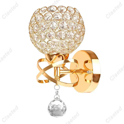 European gold crystal wall light featuring a gold-toned wall sconce with spherical crystal globe and faceted pendant