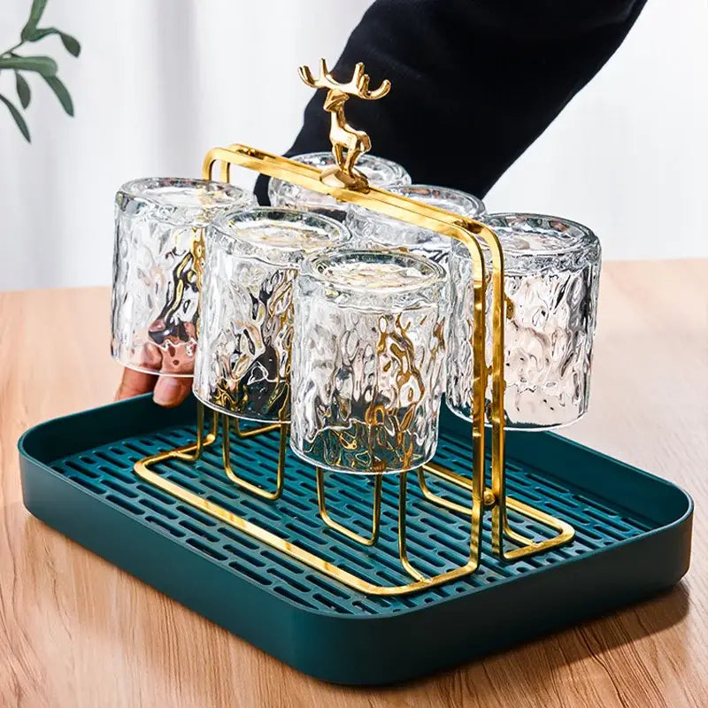 European gold deer glass storage rack with textured clear glass cup holder and teal plastic tray base for dining room