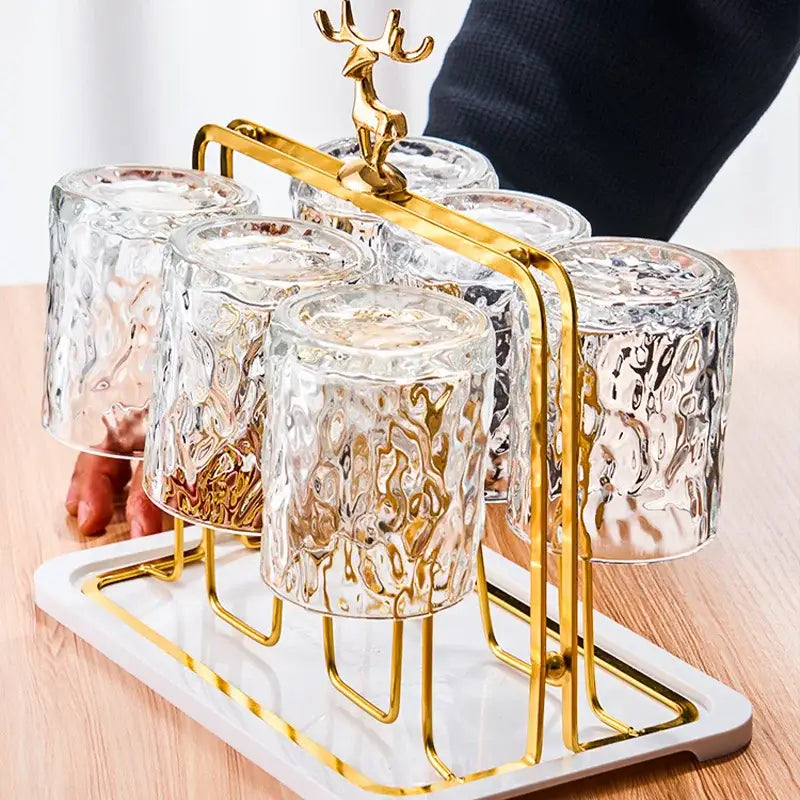 European gold deer glass storage rack with bamboo tray and cup holder holding six textured clear drinking glasses