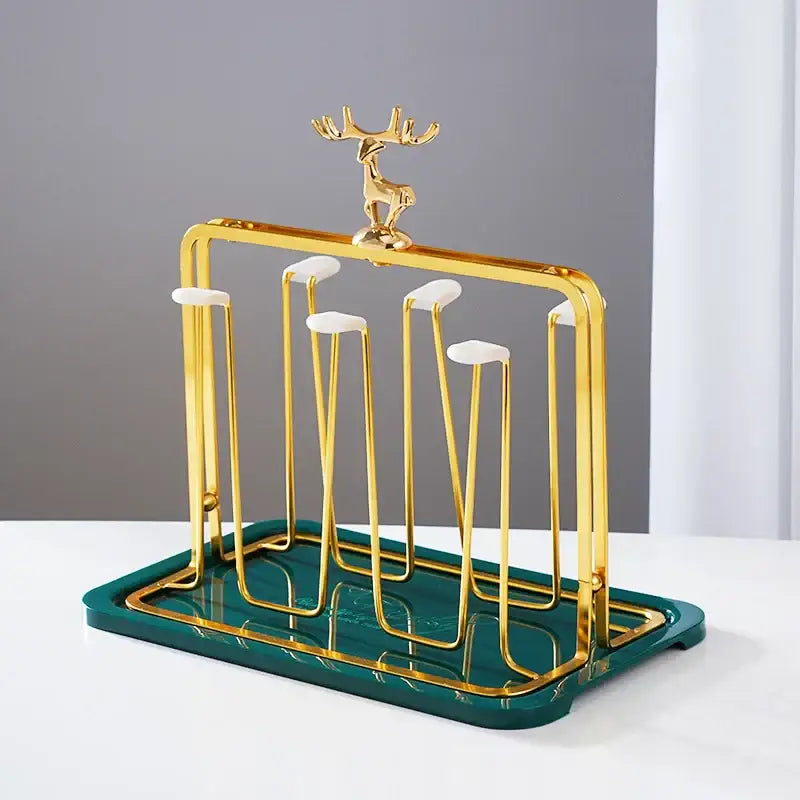European gold deer glass storage rack with gold cup holder and white ceramic accents on dark green bamboo tray
