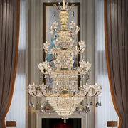 A duplex european crystal chandelier with gold-toned metalwork and hanging crystals for staircase lighting