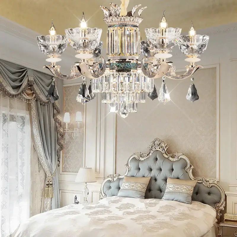 Opulent duplex european crystal chandelier with silver-toned metalwork and intricate crown-like detailing for staircase lighting