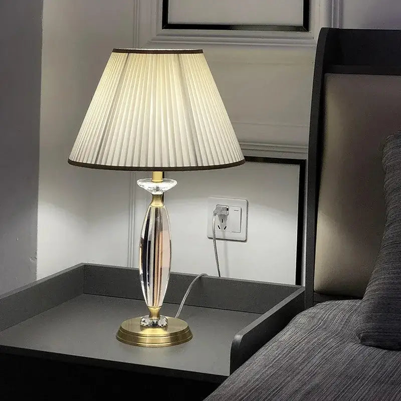 Elegant crystal floor lamp with gold-toned base and pleated off-white fabric shade for living room decor