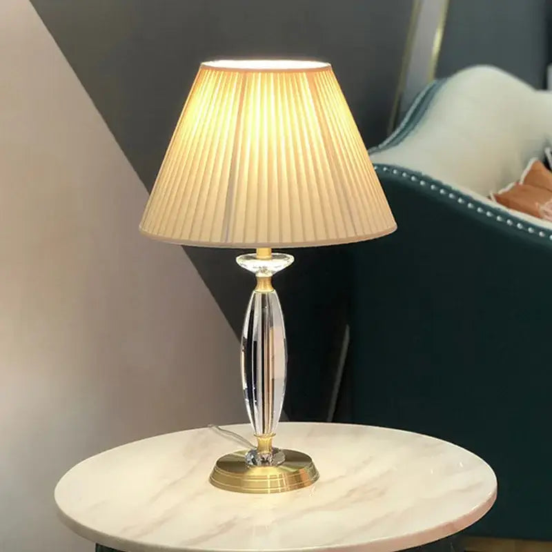 Elegant crystal floor lamp with gold-finished base and beige pleated fabric shade for living room decor