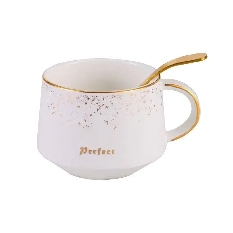 White ceramic coffee cup with gold speckles and rim featuring perfect lettering in european style coffee cup set