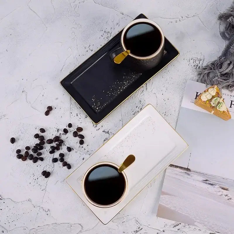 Black ceramic coffee cup with gold rim and handle on matching tray from european style ceramic coffee cup set