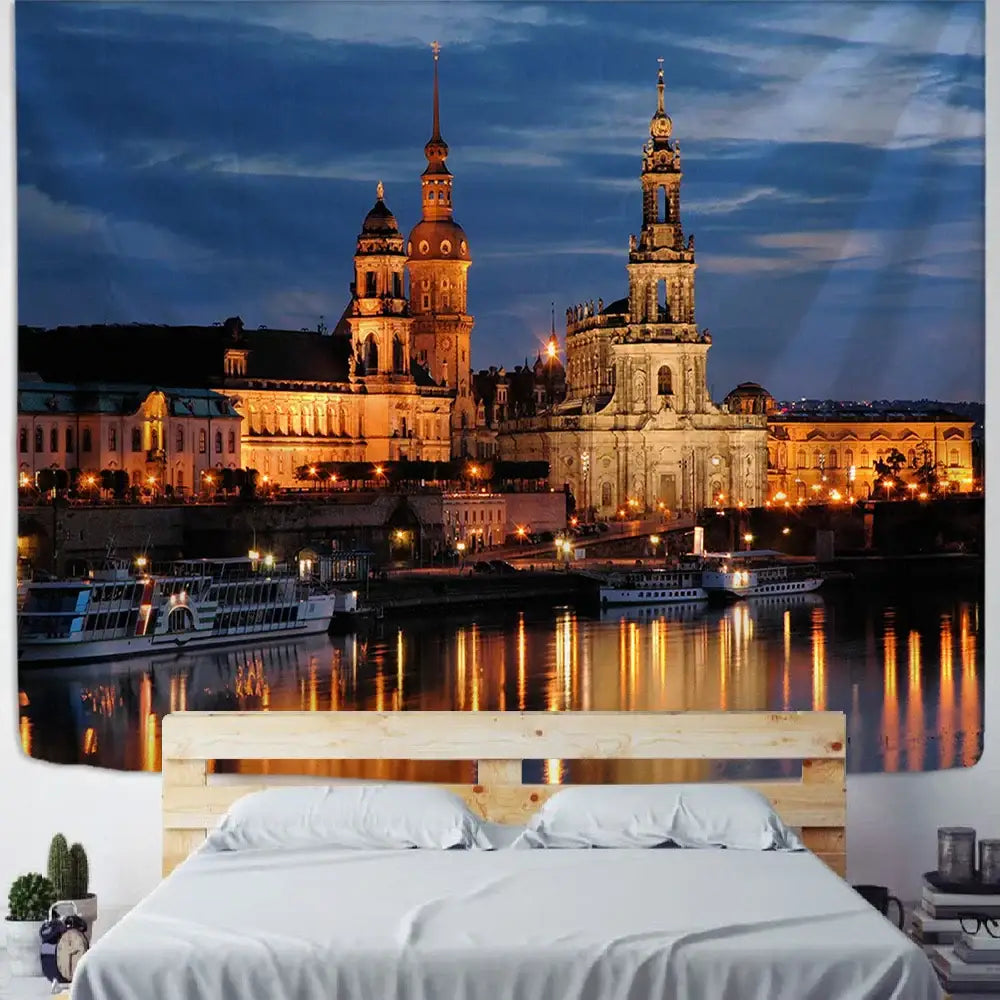 A large rectangular tapestry featuring a detailed european city night scene with illuminated historic buildings and boats