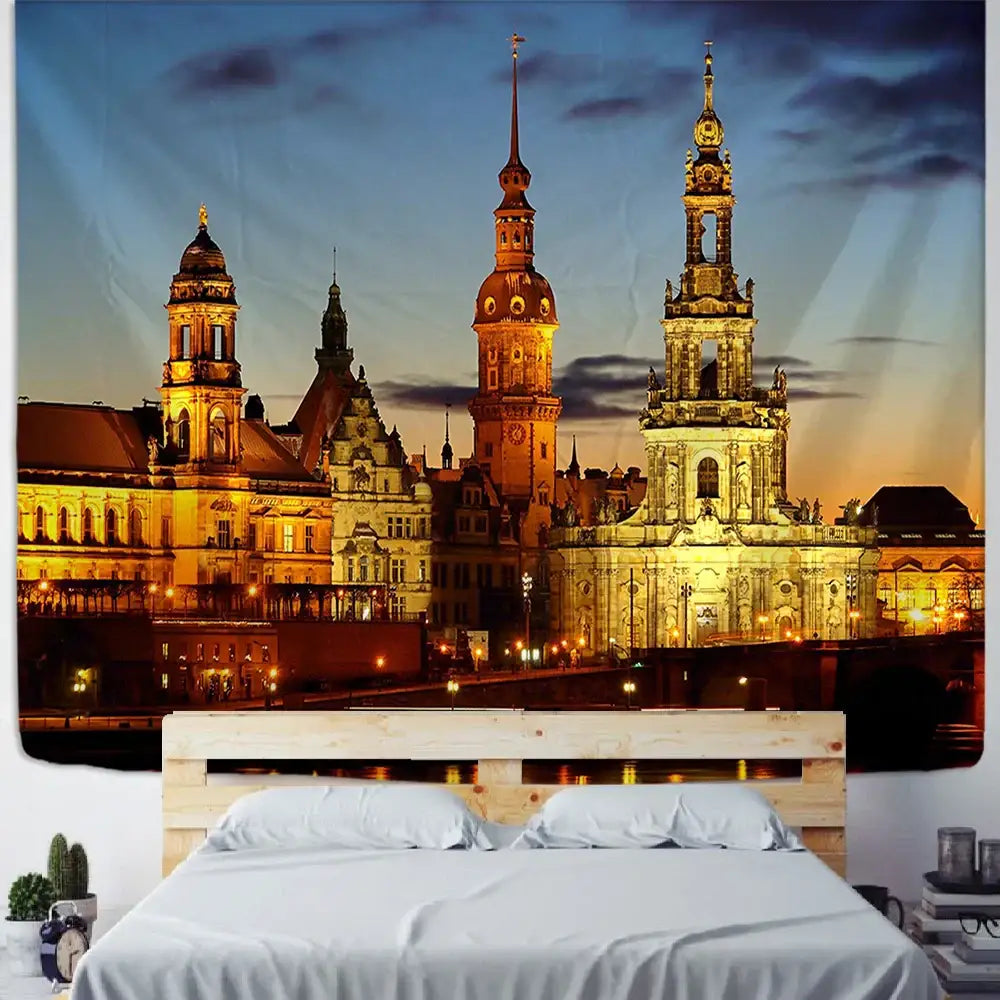 A vibrant golden European style city night scene tapestry depicting dresden architecture hangs above a wooden bed frame