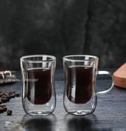European style clear double glass insulated tea cups with handles filled with dark liquid for kitchenware use