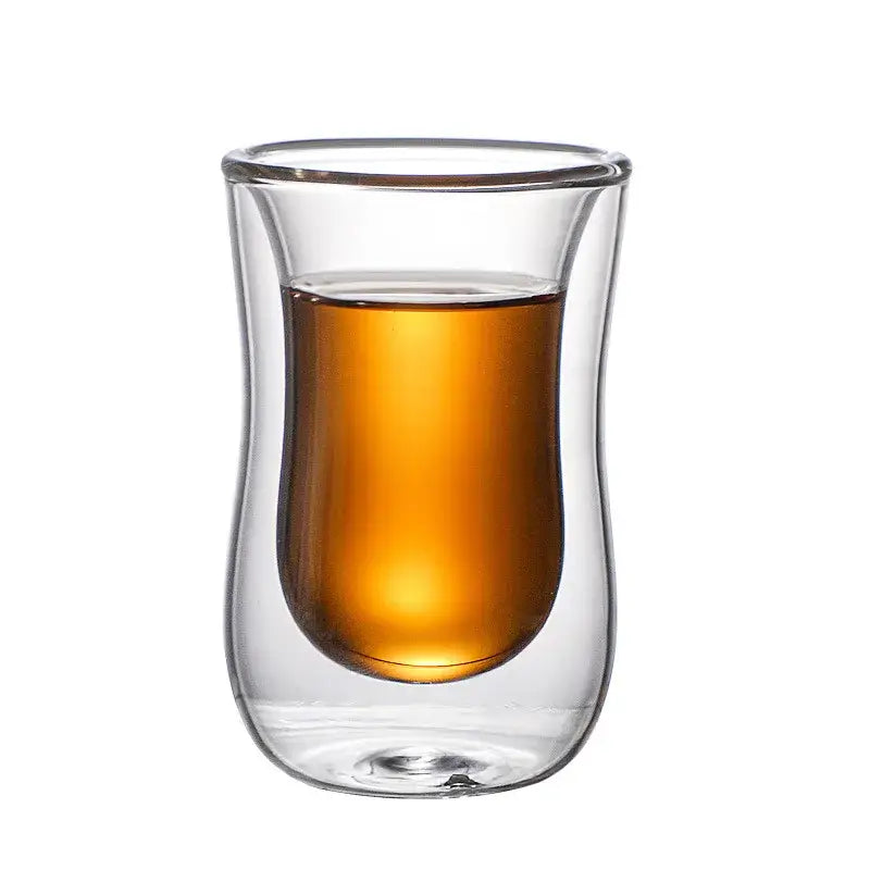 A clear double glass insulated tea tumbler filled with amber liquid for European style kitchenware use