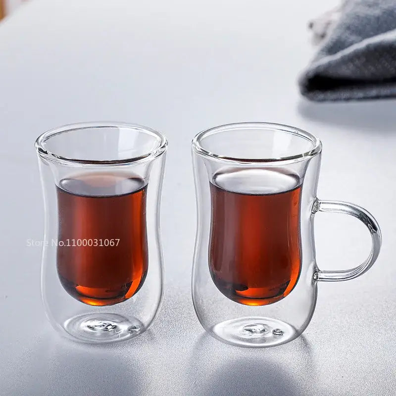 European style clear double glass insulated tea cup set with amber liquid in clear glass mugs with handles for kitchenware