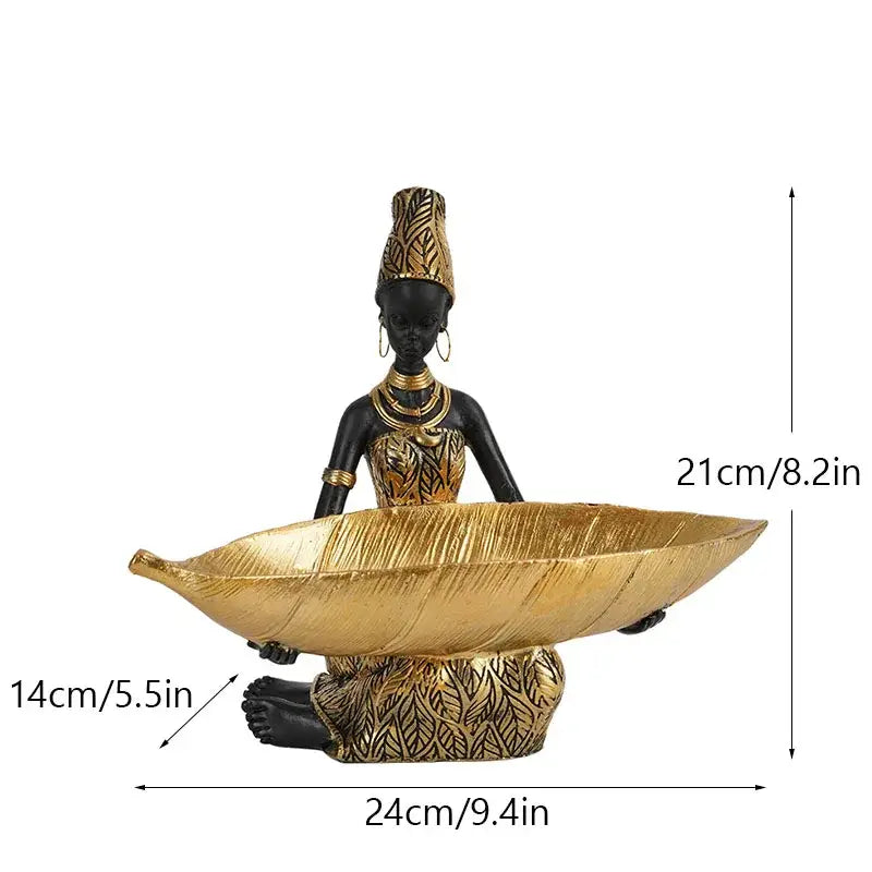 Exotic black african woman resin figurine in black and gold holding a golden leaf bowl for living room decor