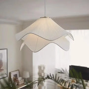 A white paper fabric petal pendant light with delicate petal design by decorbites for dining room decor