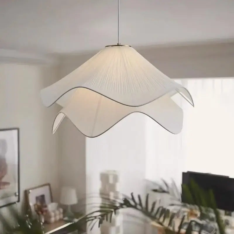 A white paper fabric petal pendant light with delicate petal design by decorbites for dining room decor