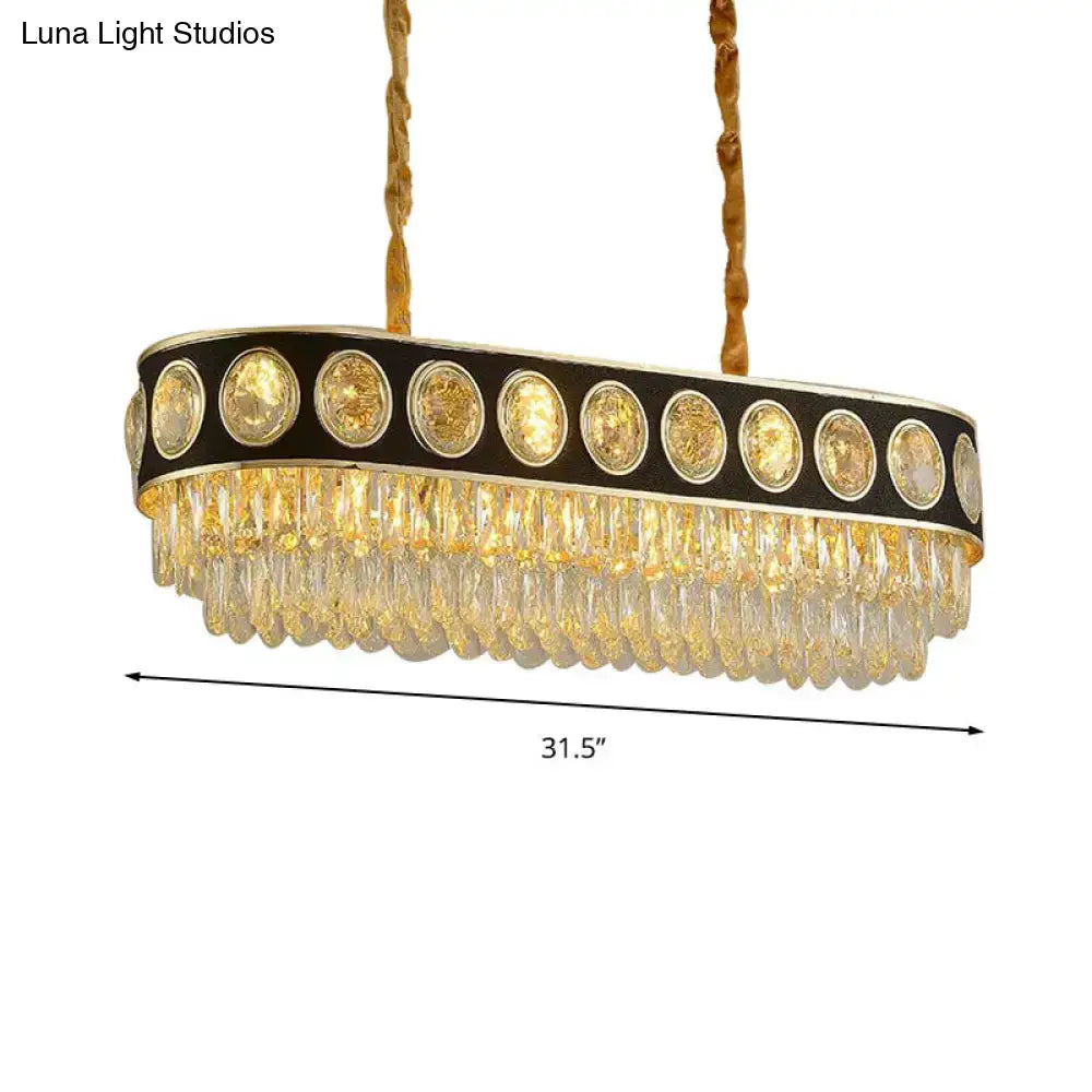 Elegant DecorBites™ faceted crystal pendant light with black and gold frame and golden oval crystals for dining room island