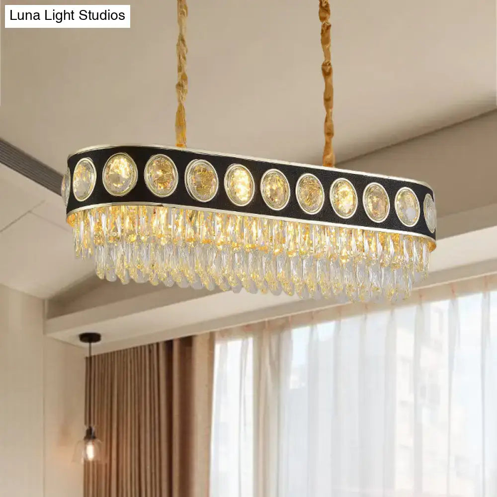 Elegant black and gold faceted crystal pendant light with oval shape and crystal droplets for dining room island lighting