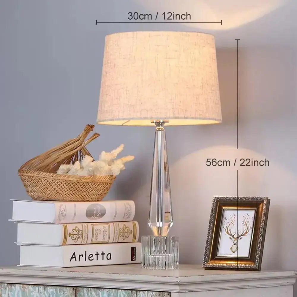 Faceted crystal table lamp with a beige linen fabric shade by Decorbites for elegant bedroom lighting decor