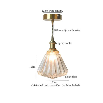 A clear faceted glass pleats led pendant light with brass finish metal components for dining room use