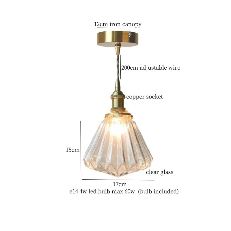 A clear faceted glass pleats led pendant light with brass finish metal components for dining room use