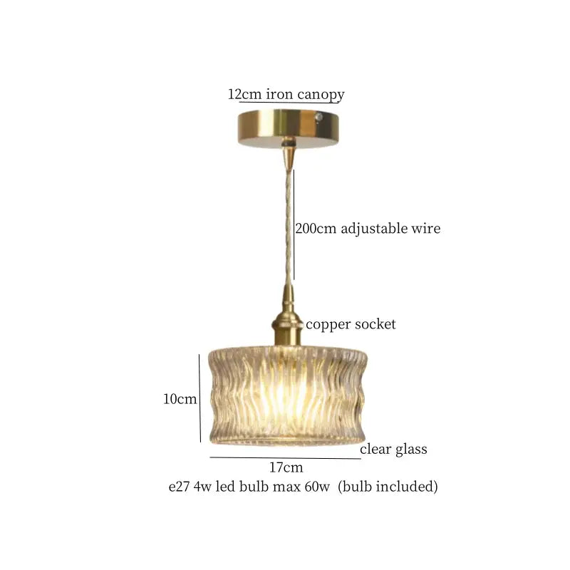 A brass-finished pleats led pendant light with clear ribbed glass shade and adjustable suspension for dining room