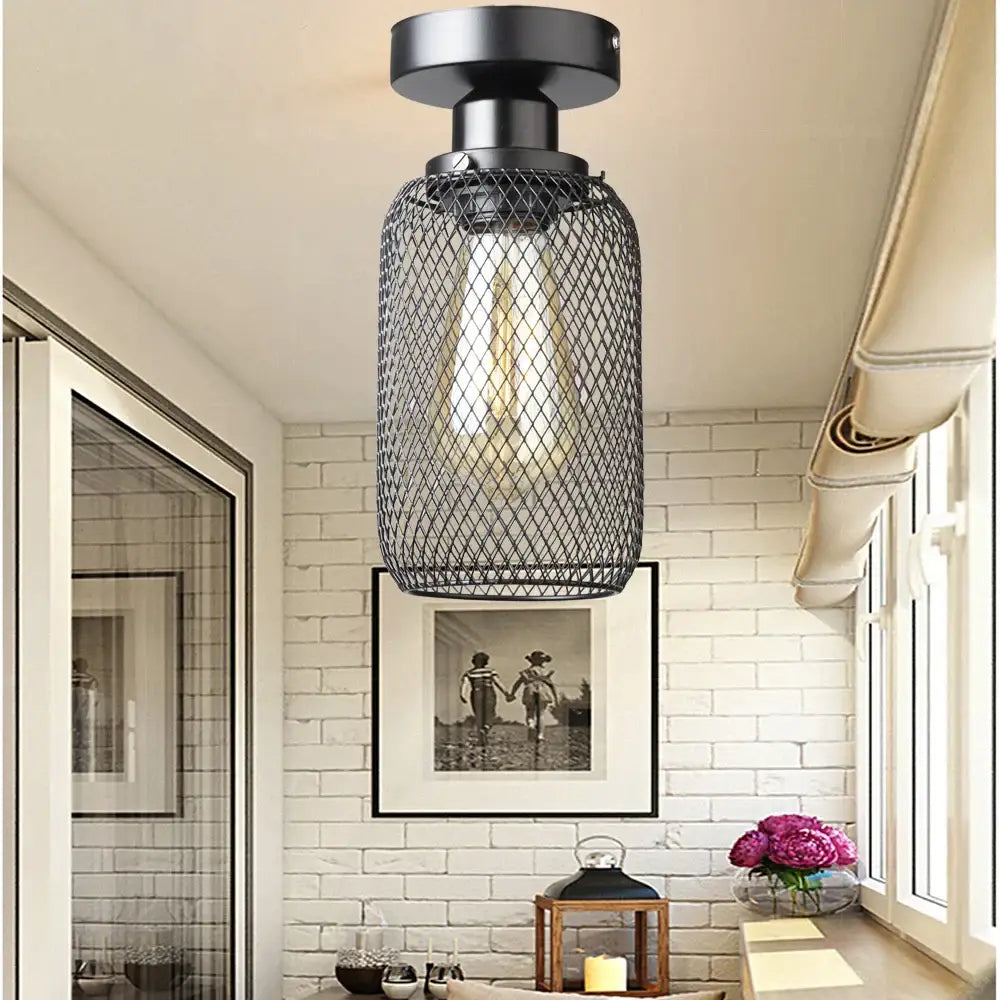 Farmhouse black metal cage ceiling light with cylindrical mesh design and exposed bulb by decorbites black metal
