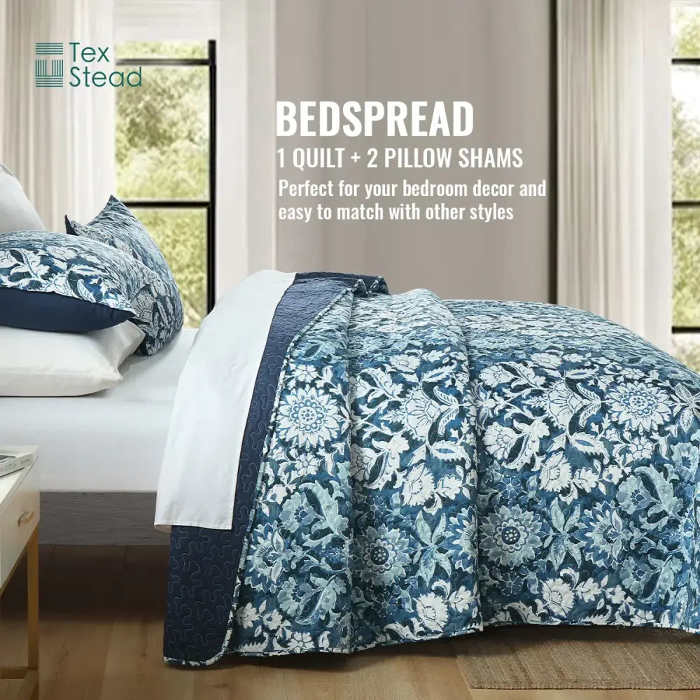 Blue and white floral quilted bedding set with intricate embroidery and solid navy border for farmhouse bedroom decor