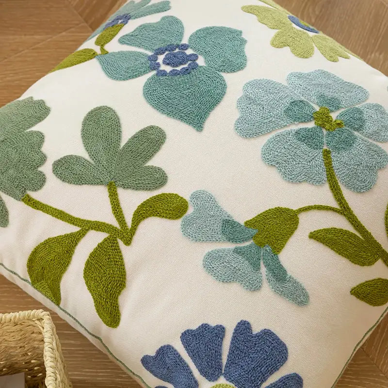 Cream-colored pillow cover with embroidered blue and green floral patterns perfect for decorbites decorative farmhouse decor