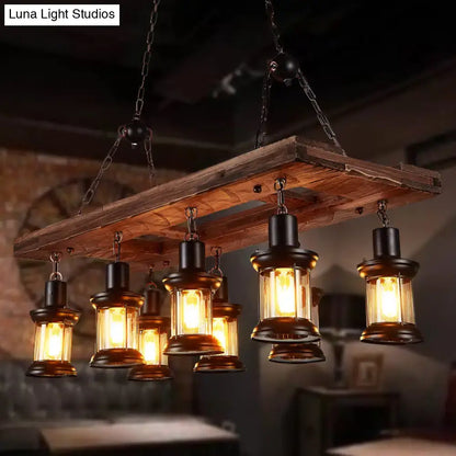 Rustic wooden plank chandelier with farmhouse clear glass lanterns featuring black metal frames and warm amber shades
