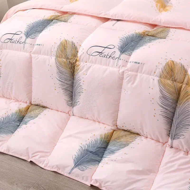 Pink feather-themed white goose down quilt with blue and gold accents and elegant feather script for winter bedding
