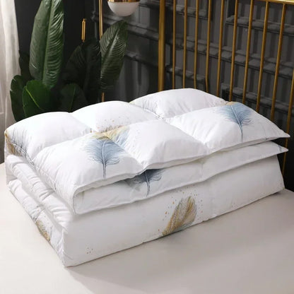 White goose down quilt in white with delicate blue and gold feather embroidery for winter bedding comfort