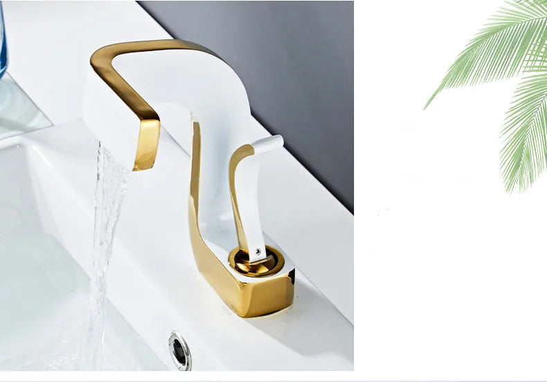 Gold-toned single hole bathroom faucet with sleek curved spout and brass housing material for luxury washbasin use