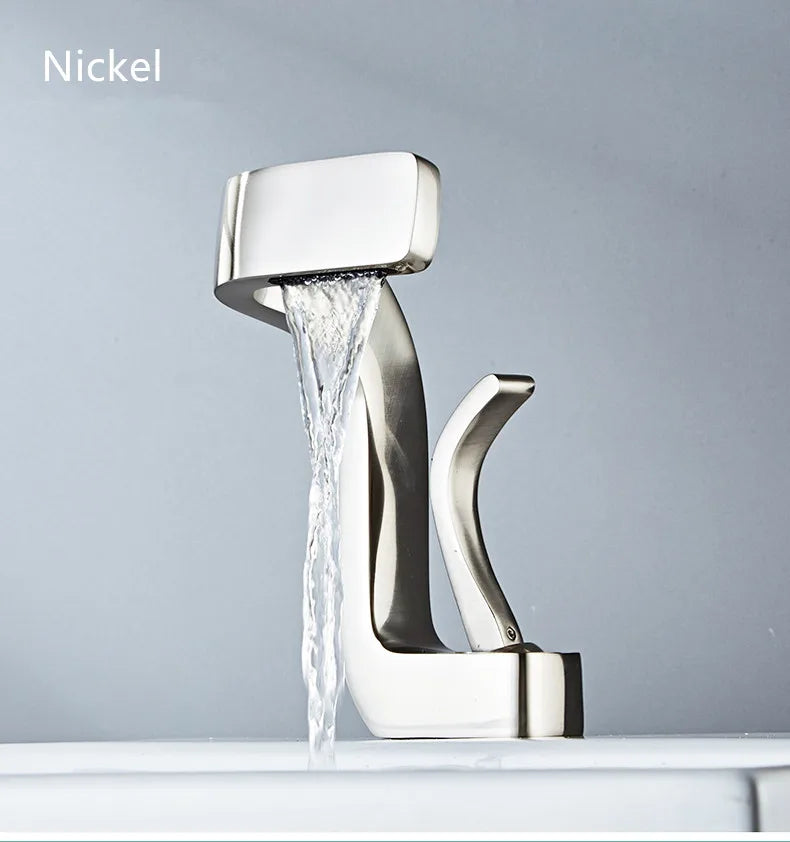 Modern single hole nickel-finished brass bathroom faucet with sleek angular design and flowing waterfall water stream