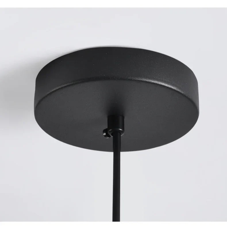 Black matte felt pendant light with a circular acoustic design for modern office spaces