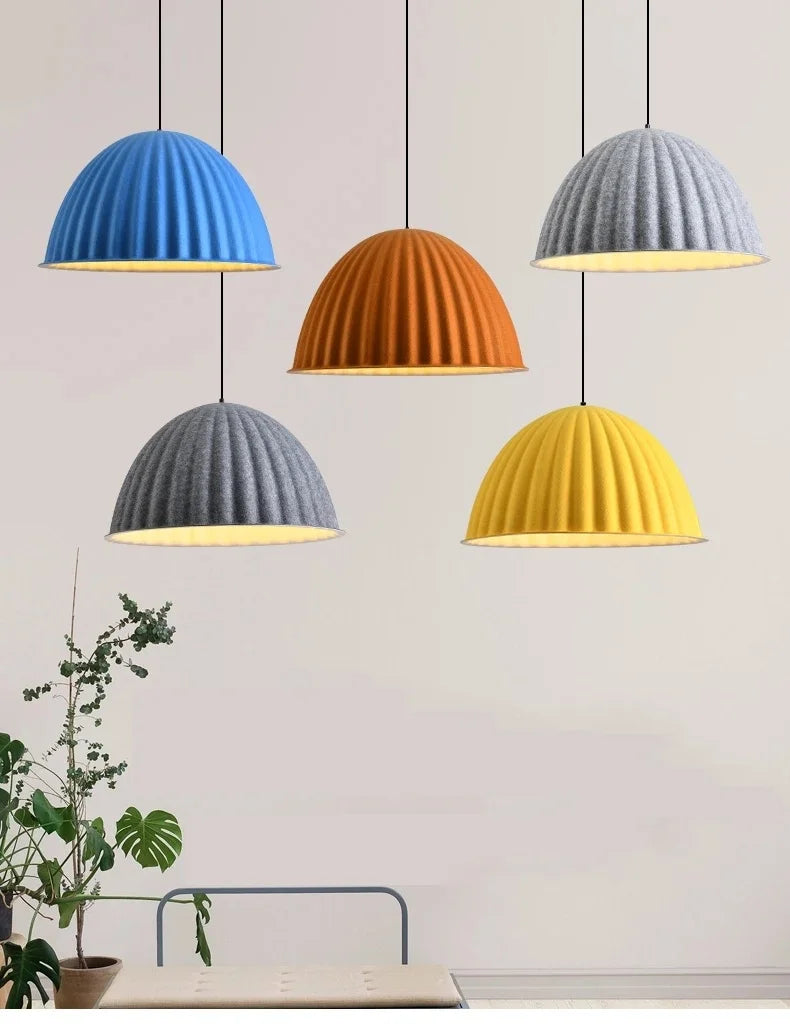 Four colorful felt pendant lights in blue orange gray and yellow with ribbed design for acoustic office use