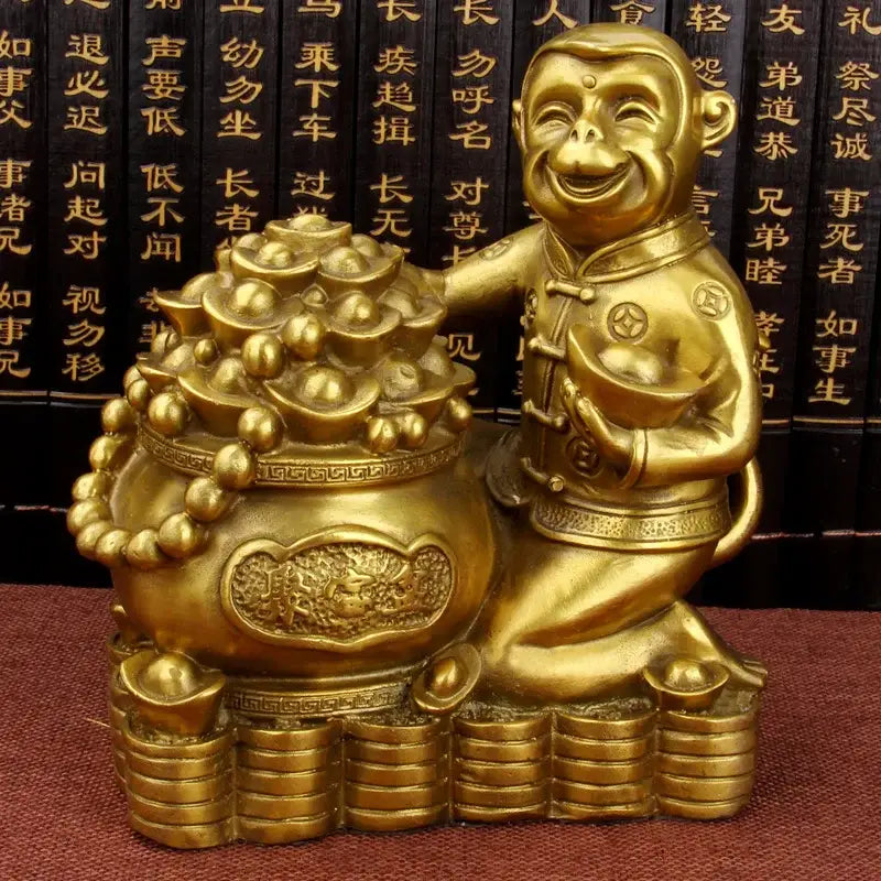 Golden brass copper monkey figurine kneeling beside ornate copper monkey cornucopia overflowing with coins for wealth decor
