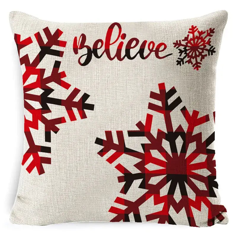Beige linen throw pillowcase with bold red and black plaid snowflake design and believe script for elk print linen decorbites